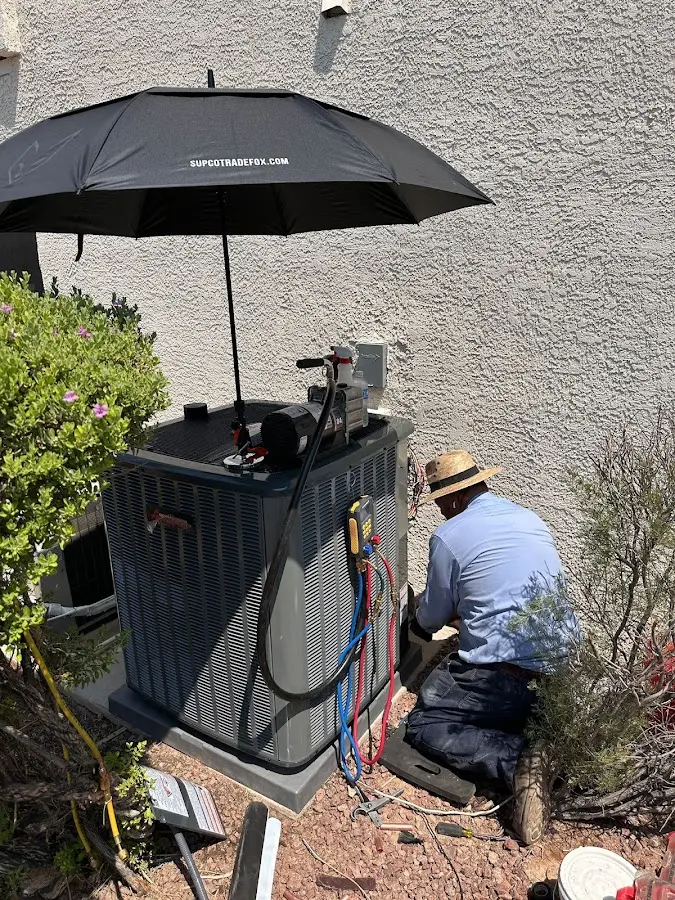 HVAC technician performing outdoor AC maintenance in West Hattiesburg